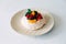 Tasty Pavlova dessert with white meringue, cream and fruit