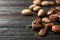 Tasty pecan nuts scattered on wooden table.