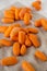 Tasty peeled baby carrots on cloth, side view. Closeup