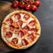 Tasty pepperoni pizza and tomatoes on black background.