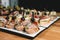 Tasty pinchos with tuna, chorizos, salmon, egg, dried tomatoes, avocado, salmon, bacon, Hamon, Brie Cheese, Olives and