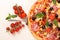 Tasty pizza, basil, tomatoes and shovel on white background