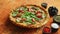 Tasty pizza on a rusty background with spices, herbs and vegetables