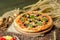 Tasty pizza with vegetables and basil