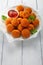 Tasty potato croquettes - mashed potatoes balls breaded and deep fried, served with ketchup on white plate,
