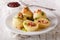 Tasty potato dumplings with bacon and parsley topped with butter
