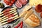 Tasty prosciutto with bread served on marble table, flat lay