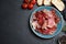 Tasty prosciutto served on black table. Space for text