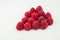 Tasty raspberry on white backgroun heart shaped