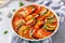 Tasty Ratatouille in baking dish on white background. Traditional French Provencal vegetable dish. Dieting, vegan food.