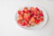 Tasty ripe strawberries on the table, summer seasonal healthy red berry on a white plate