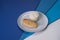 Tasty roasted chicken fillet on gray plate with boiled white rice served in culinary ring on colorful blue background