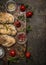 Tasty roasted chicken fillet with herbs,spices,seasoning and tomatoes on vintage gutting board over rustic wooden background, top