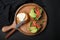 Tasty rusks with salmon, cream cheese and avocado served on black table, flat lay