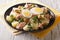 Tasty salad of boiled potatoes, tuna, eggs, olives dressed with