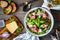 Tasty salad - prosciutto di Parma, parmesan and fresh, green vegetables on wooden table, top view