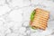 Tasty sandwich with  toasted bread on white marble table, top view. Space for text