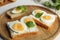 Tasty sandwiches with boiled eggs on tray, closeup