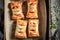 Tasty sausage in puff pastry with tatar sauce and herbs