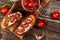 Tasty savory Italian appetizers, or bruschetta, on slices of toasted baguette garnigoat cheese, sun-dried tomatoes and garlic,