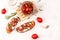 Tasty savory Italian appetizers, or bruschetta, on slices of toasted baguette garnigoat cheese, sun-dried tomatoes and garlic,