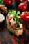 Tasty savory tomato Italian bruschetta, on slices of toasted baguette garnished with parsley and eggplant