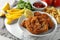 Tasty schnitzels served with potato fries, ketchup and vegetables on marble board, closeup