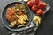 Tasty schnitzels served with potato fries, tomatoes and arugula on grey table, flat lay