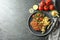 Tasty schnitzels served with potato fries, tomatoes and arugula on grey table, flat lay. Space for text