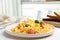 Tasty scrambled eggs with sprouts and cherry tomato on white table