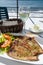 Tasty seafood, grilled tuna fish steaks served on outdoor terrace on Puerto Naos, La Palma, Canary islands, Spain