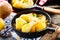 Tasty serving of raclette on potatoes with herbs