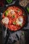 Tasty shakshuka with eggs, tomatoes and herbs