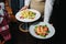 Tasty slice of fried salmon served with mix salad of kale leaves, cherry tomatoes and bocconcini cut in halves, cucumber, served