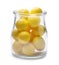 Tasty small lemon drops in glass jar isolated