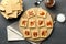 Tasty snack concept with cookies with caramel on dark wooden table