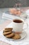 A tasty snack: a cup of tea and a plate of cookies