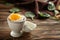 Tasty soft boiled egg in holder on wooden table