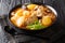 Tasty spicy Gamjatang Korean Pork Bone Soup with creamy potatoes and tender juicy pork bone meat close up in the bowl. Horizontal