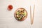Tasty spring rolls, chopsticks and sauce on white wooden table, flat lay