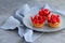 Tasty strawberry cakes on gray plate and linen napkin