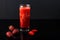 Tasty strawberry smoothie on black background. Fresh strawberry smoothie, summer drink, healthy antioxidant juice with