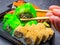 Tasty sushi bar, Eating Sushi with chopsticks. California Sushi roll set with salmon, vegetables, fish, caviar closeup. Japan
