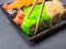 Tasty sushi bar, Eating Sushi with chopsticks. California Sushi roll set with salmon, vegetables, fish, caviar closeup. Japan