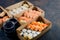 Tasty sushi rolls in disposable kraft paper boxes, sauces, chopsticks. Sushi for take away or delivery