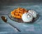 Tasty sweet breakfast with waffles and ice cream on a glass figured plate with ice cream balls and chocolate chips. Serving on a