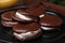 Tasty sweet choco pies on black plate