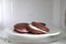 Tasty sweet choco pies on plate in microwave