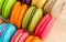 Tasty Sweet Macaroons on wooden background