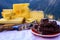 Tasty Swiss cheeses and dark pure chocolate, emmental, gruyere, appenzeller served outdoor with Alpine mountains peaks on